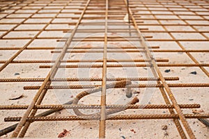 Ground steel reinforcement and steel reinforcement are provided for strength. Construction before pouring concrete requires