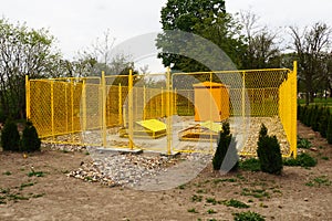 ground with tanks for liquefied gas. Modern gas installation with protective fencing. Yellow fence. Supply of gas to