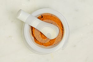 Ground tumeric in pestle and mortar