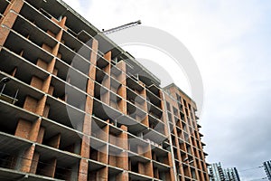 Ground view of a new modern residential house building under construction. Real estate development concept. Multi story home from