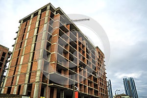 Ground view of a new modern residential house building under construction. Real estate development concept. Multi story home from