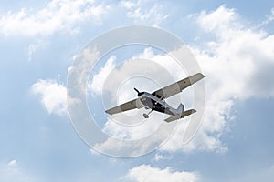 Ground view of a small plane flying