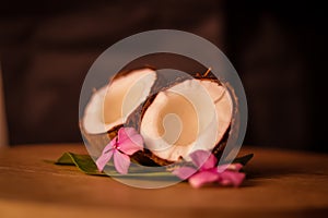 Grounded coconut flakes,half coconut with green leaves wooden on background,hd footage of coconut milk and half coconut on wooden