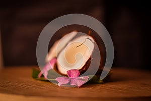 Grounded coconut flakes,half coconut with green leaves wooden on background,hd footage of coconut milk and half coconut on wooden
