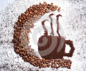 Coffee art on a table with coffeebeans photo