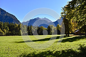 On the grounds of the Hirschau peninsula in Berchtesgaden with green meadows and mountains in the background photo