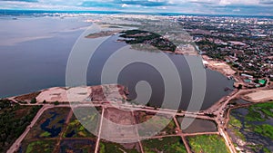 Grounds for silt manufacturing on riverbank aerial view