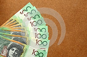Group of 100 dollar Australian notes on wood background