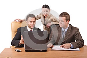 Group of 3 business people working together with laptop in the office - horizontal, isolated