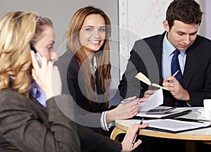 Group of 3 businesspeople sitting at table