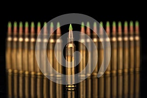 A group of 5.56 calibar, green tip bullets ordered into the lines on black background