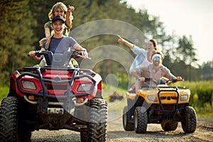 Group of active friends driving quads together photo