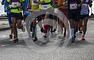 Group of active people running,marathon runners on the city road