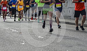 Group of active people running,marathon runners on the city road