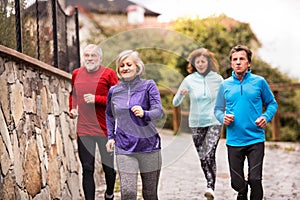 Group of seniors running outdoors in the old town.