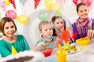 Group of adorable kids having fun at birthday party, selective focus