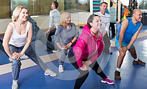 Group of adults doing aerobics exercise in sport club