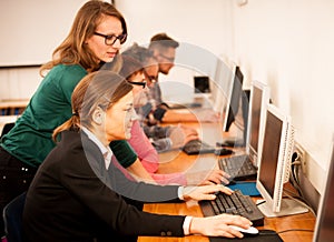 Group of adults learning computer skills. Intergenerational tran