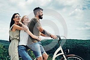 Group adventure with happy and smiling. Woman riding on bike on road along trail on mountain. Camping, jungle adventure