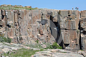 Group of adventurous climbers ascending a steep and rocky slope with determination and teamwork