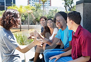 Group of african american and latin people welcoming a caucasian photo