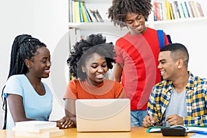 Group of african american and latin students editing video clip at computer