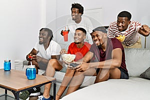 Group of african american people smiling happy playing video game at home