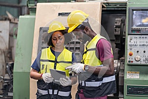 group of African American worker Industrial Engineers man and inspector manager woman checking and repair mechanical with tablet