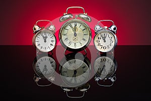 Group of alarm clocks, red background