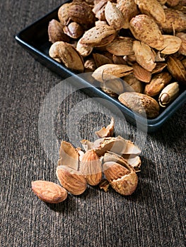 Group almond on black dish.