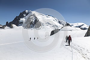 Group of alpinists climb Mont-blanc du Tacul, view from Aiguille du Midi in the French Alps, Chamonix-Mont-Blanc, France