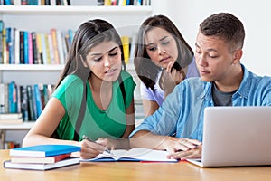 Group of american and latin students learning coding