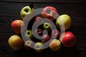 Group of apples different sizes on a wooden surface