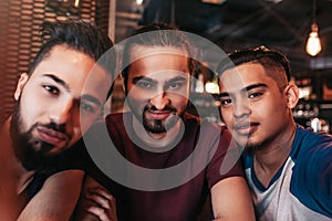 Group of arabian friends taking selfie in lounge bar. Mixed race best friends having good time together