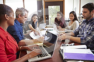 Group Of Architect Working At Desk On Computer