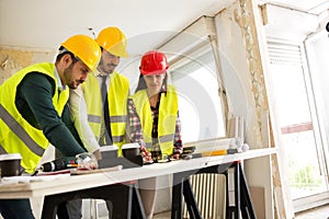 Group of architects consult about the project on construction si