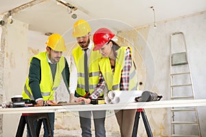 Group of architects consult about the project on construction si