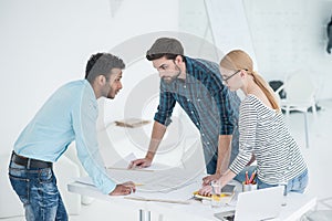 Group of architects discussing plans in modern office