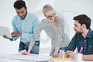 Group of architects discussing plans in modern office