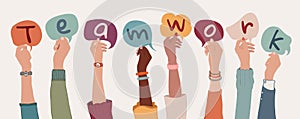 Group of arms and raised hands of diverse people holding a speech bubble with letters inside forming the text -Teamwork- Community