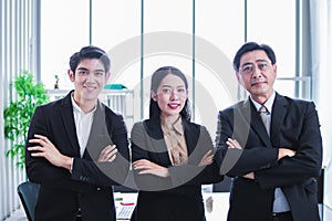 Group of asia successful business people standing cross arm.Diverse business team smiling to camera in office