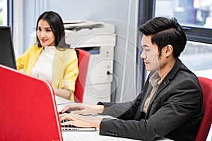 Group of Asian Attractive young business man and woman work on computer in office. Team of beautiful employee worker in casual