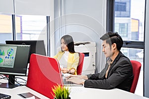 Group of Asian Attractive young business man and woman work on computer in office. Team of beautiful employee worker in casual sui