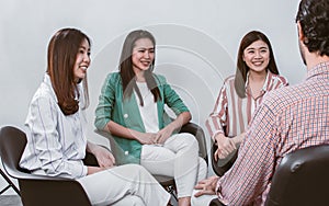 Group of asian beautiful women wearing casual business shirt, smiling, discussing, talking, doing workshop in indoor meeting