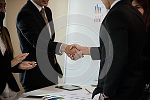 A group of Asian Business handshake of congratulations on meeting the business achieve success.