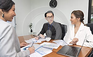 Group of Asian business people meeting about business plan and present and explain financial chart from laptop computer at office