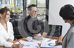 Group of Asian business people meeting about business plan and present and explain financial chart from laptop computer at office