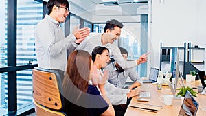 Group of Asian business people work together in team brainstorm discussion, clap hand celebrate in office