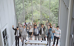Group of asian business team raising arms success achievement Concept.