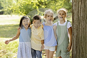 Group of asian and caucasian kids having fun in the park